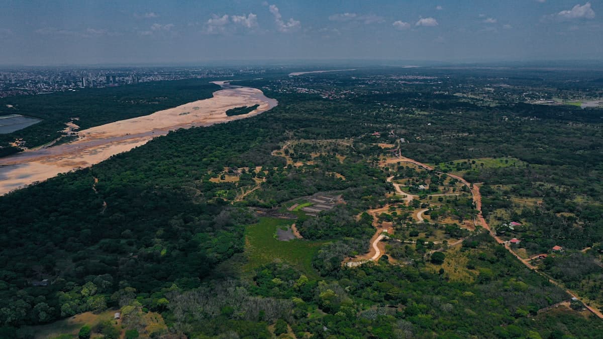 Aerial view of a river winding through dense tropical forest — the Amazon basin where the Marañón and Ucayali converge